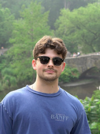 A scenic headshot of Matt smiling in sunglasses, taken in Central Park, NYC.