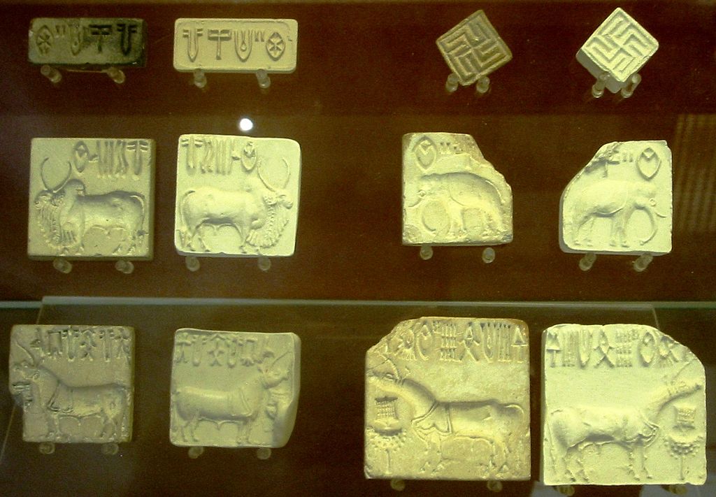 Square tiles with symbols and animals carved into them.
