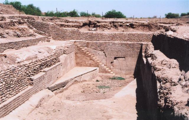 Archaeological dig. A brick-lined empty pit, formerly a water reservoir, with a set of steps leading down to the bottom.