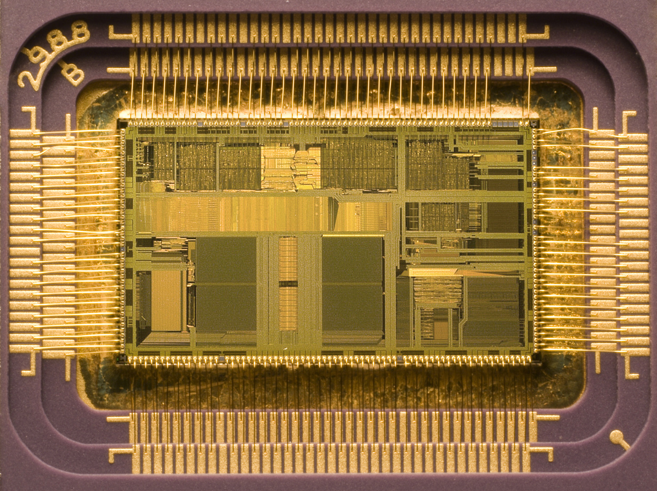 Photo of an Intel chip, covered in gold and wires.