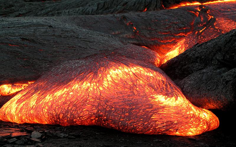 Molten lava acts as a blackbody, emitting electromagnetic radiation in the visible region at very high temperatures.