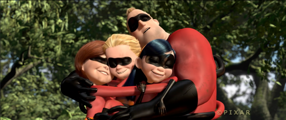 Scene from the Pixar film "The Incredibles" where the family of superheroes hug each other tightly in a forest.